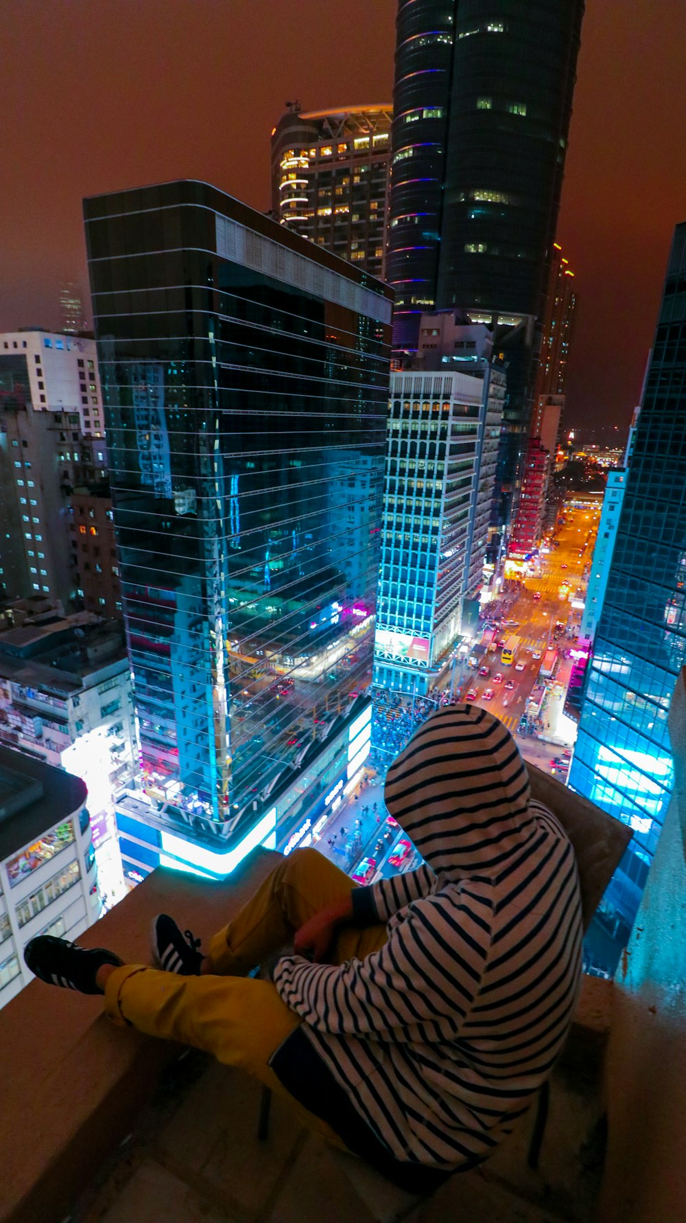 man on roof in city