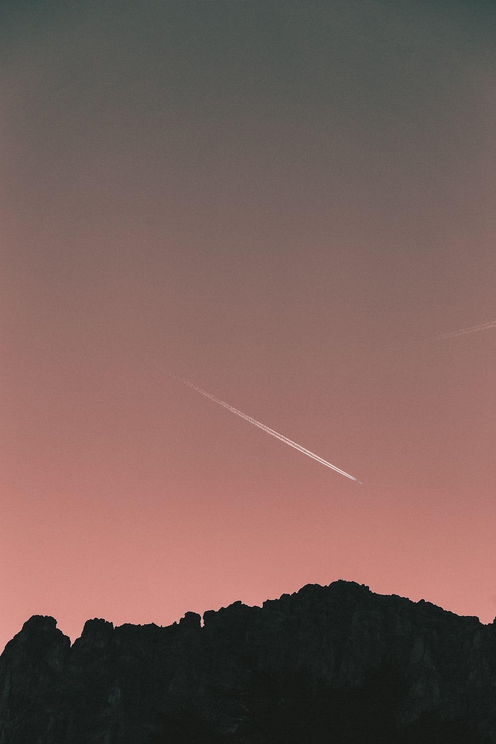 silhouette of stone hill at sunset