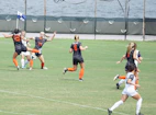 women playing soccer during daytime