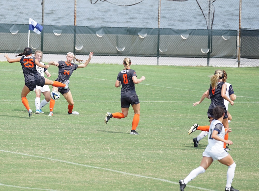 women playing soccer during daytime