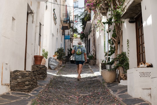 person walking on alleyway in Cadaqués Spain