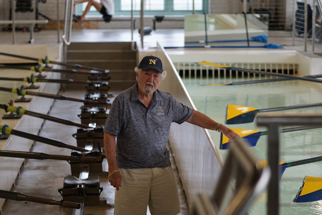man standing between paddles, Hubbard Hall