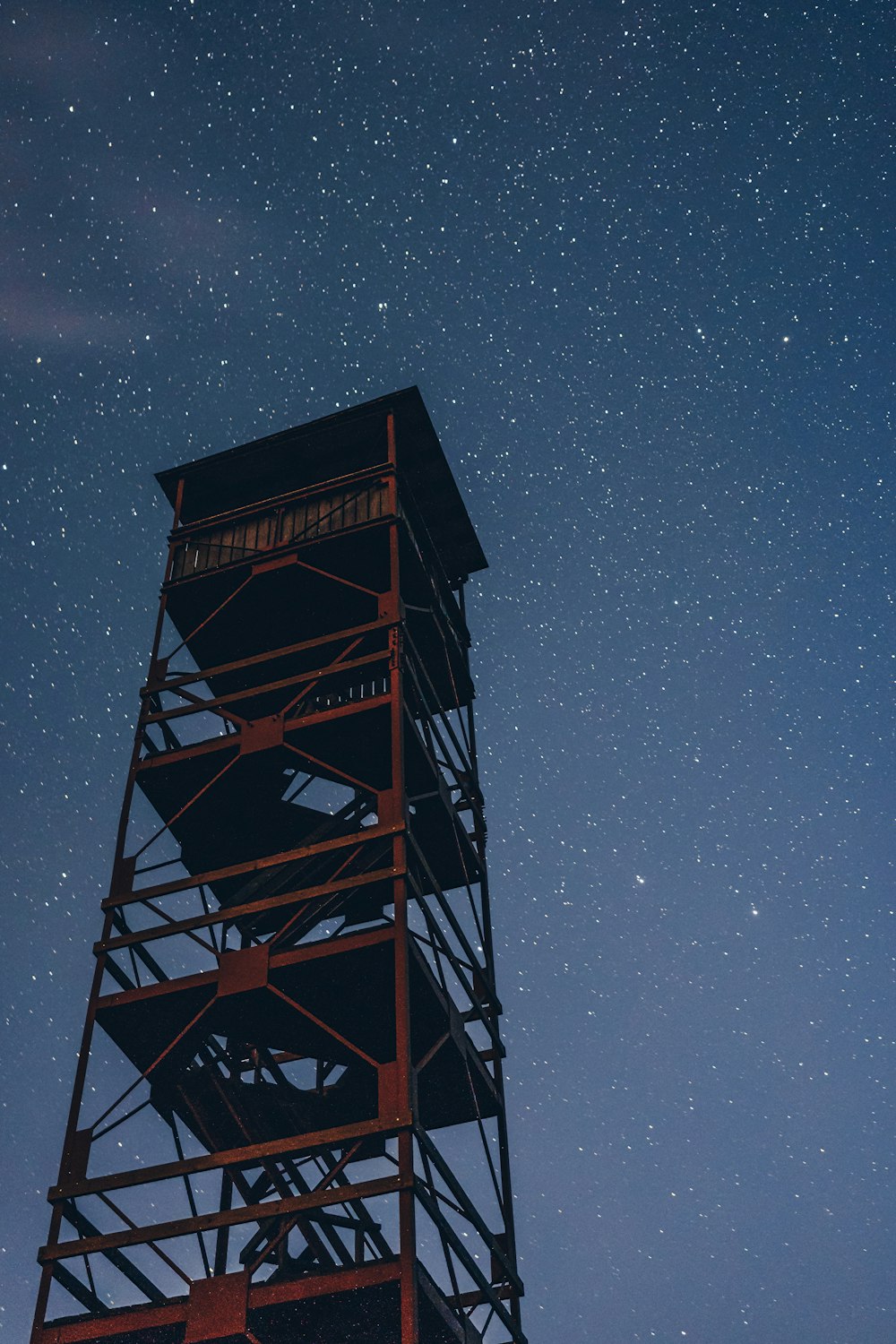 red watch tower under starry night