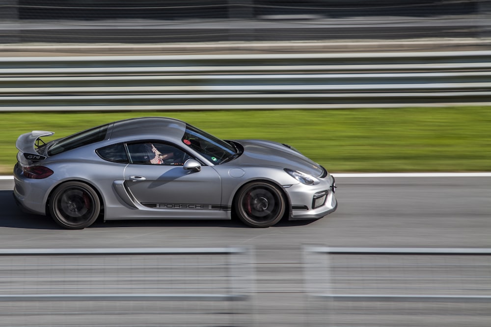 gray sports coupe on road at daytime