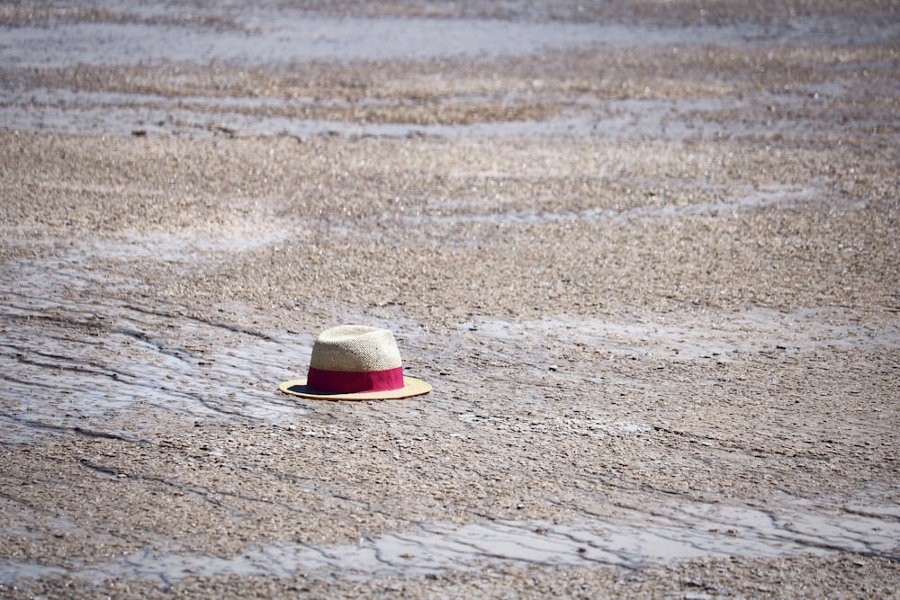 straw hat on pebble pavement