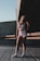 woman standing under bridge