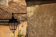 A series of outdoor wall lamps installed on a brick wall.