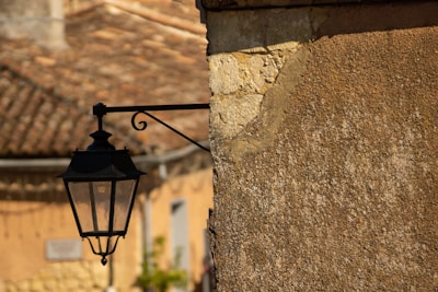 An outdoor wall lamp featuring a motion sensor.