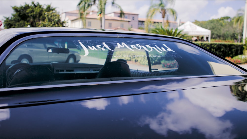 black vehicle on road with just marries vinyl