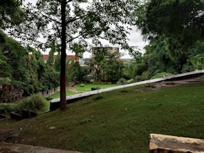 Community park area with walking paths and greenery within a Gaursons residential complex