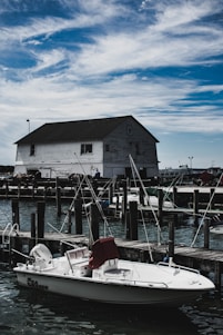 white powerboat near dock during daytime