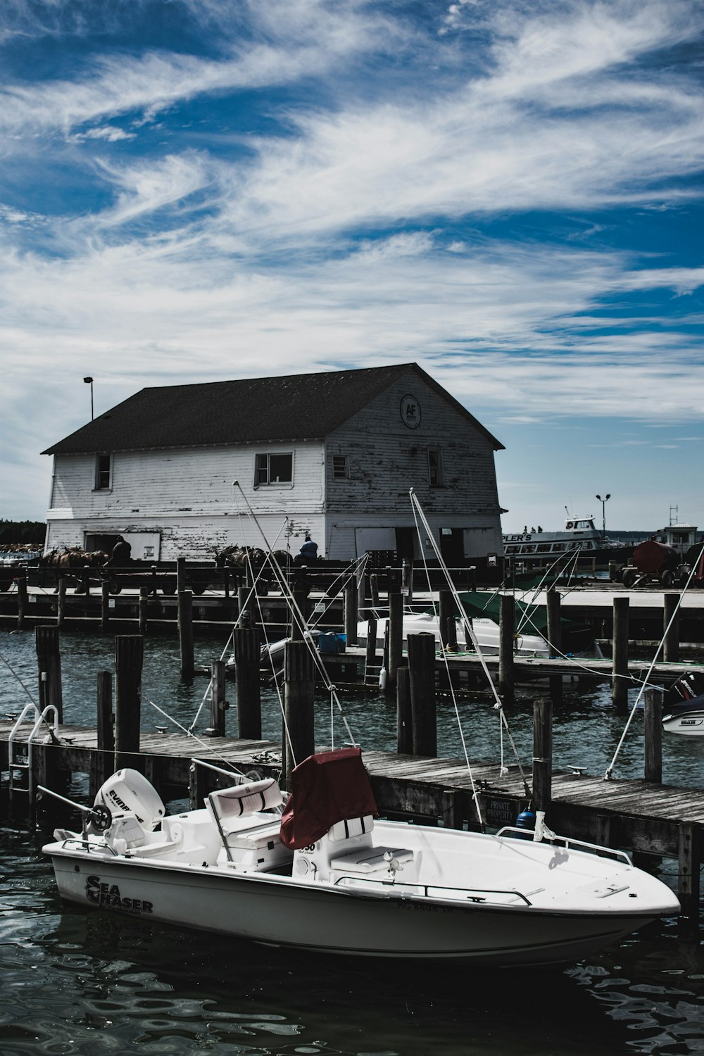 white powerboat near dock during daytime