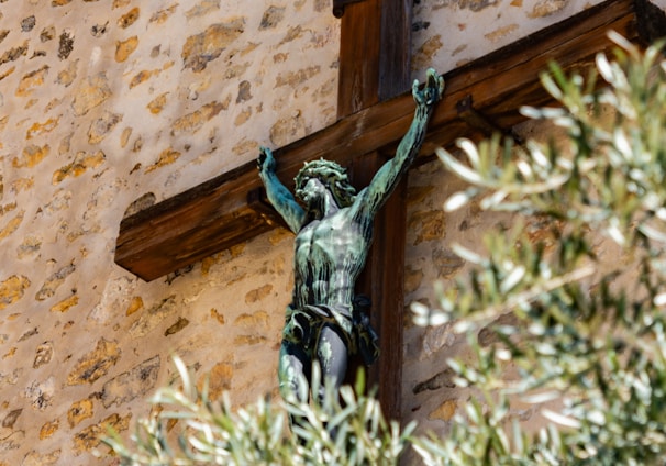 crucifix beside brown wall