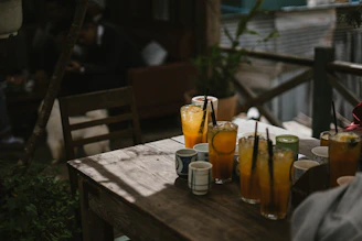 Sun-drenched outdoor table with terracotta accents and chilled beer glasses.