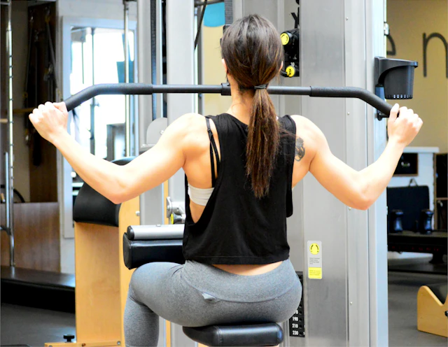 Athlete performing lat pulldown on cable machine