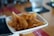 Close-up of crispy banana chips in a rustic bowl on a wooden table.
