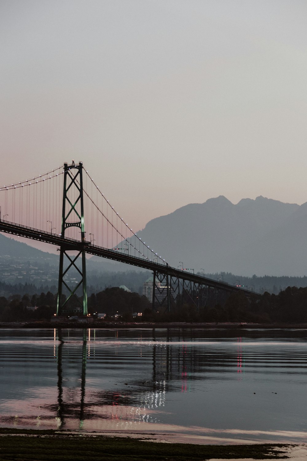 scenery of bridge in front of silhouette of mountain