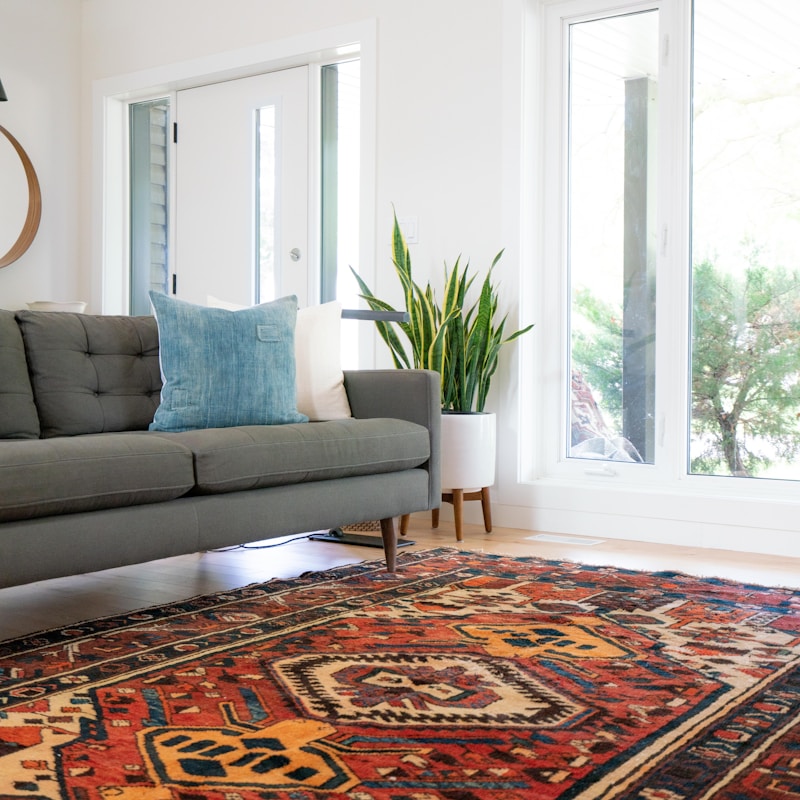 Close-up of a cream and charcoal hand-tufted wool rug with organic patterns