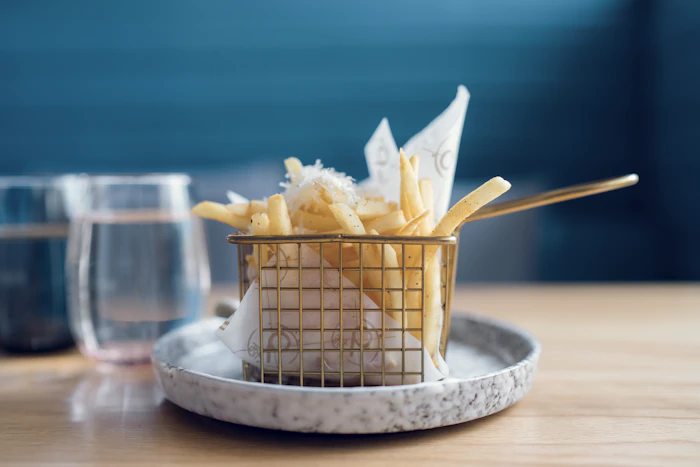Seasoned fries tossed in Properly Fried seasoning