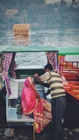 A couple enjoying a romantic boat ride on the calm waters of Nigeen Lake.