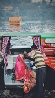A couple enjoying a romantic boat ride on the calm waters of Nigeen Lake.
