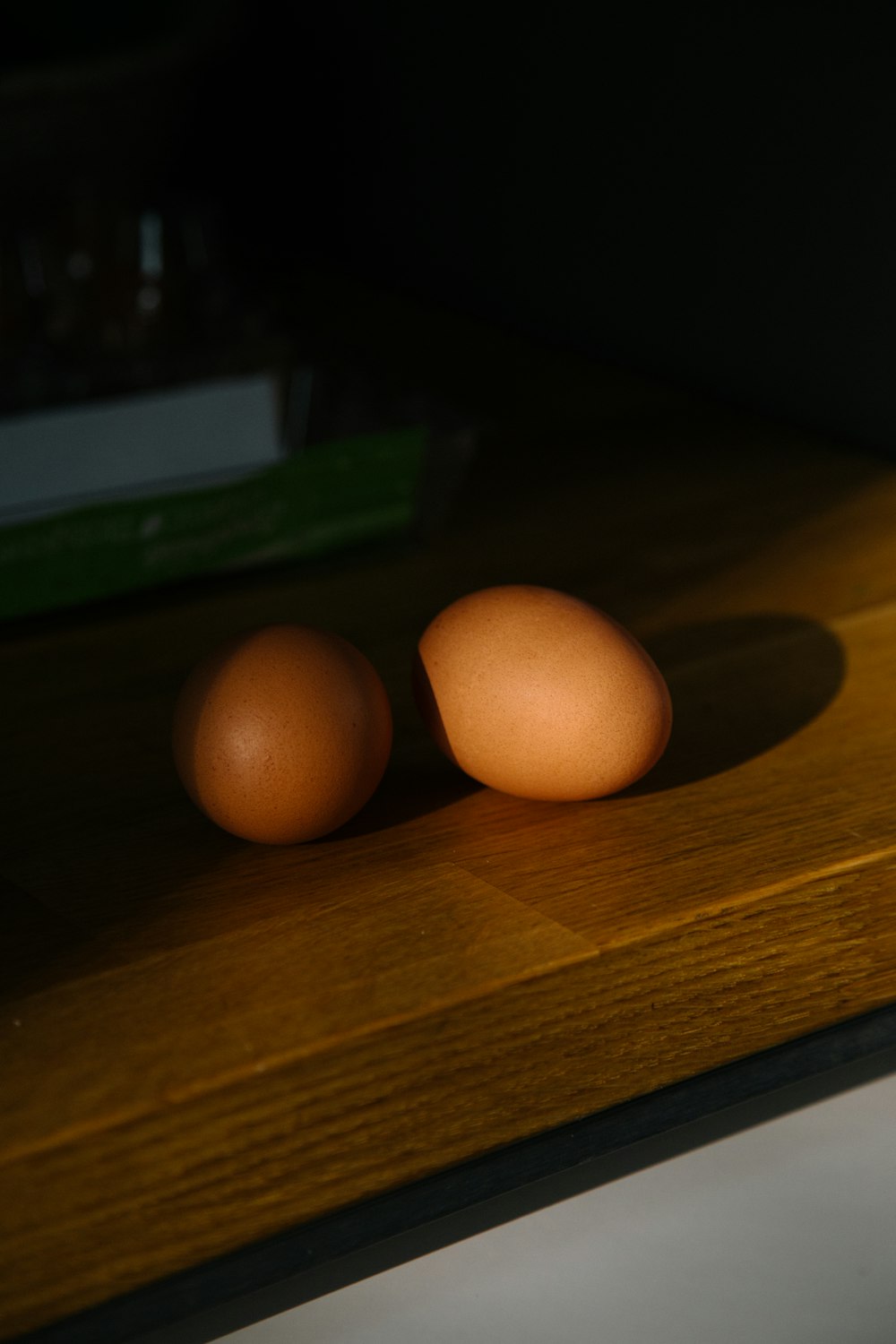 two organic eggs on brown table