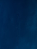 aircraft with line of air on blue sky