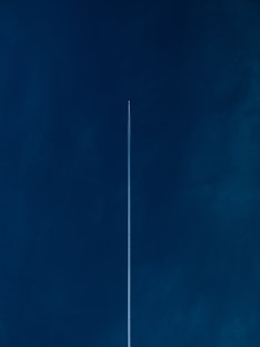 aircraft with line of air on blue sky