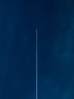 aircraft with line of air on blue sky