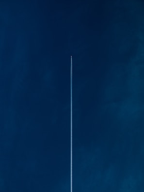 aircraft with line of air on blue sky