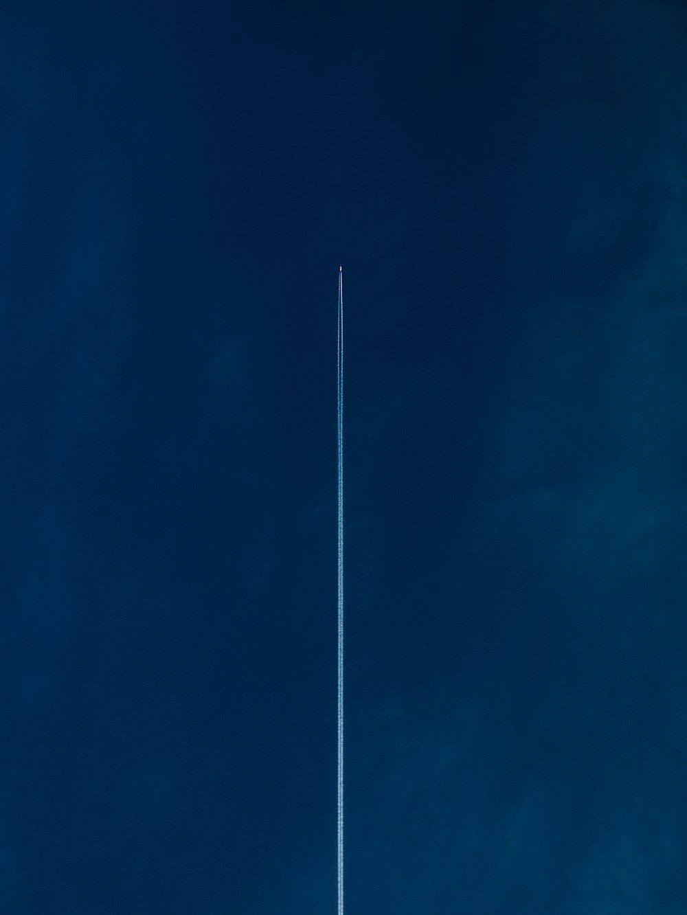 aircraft with line of air on blue sky