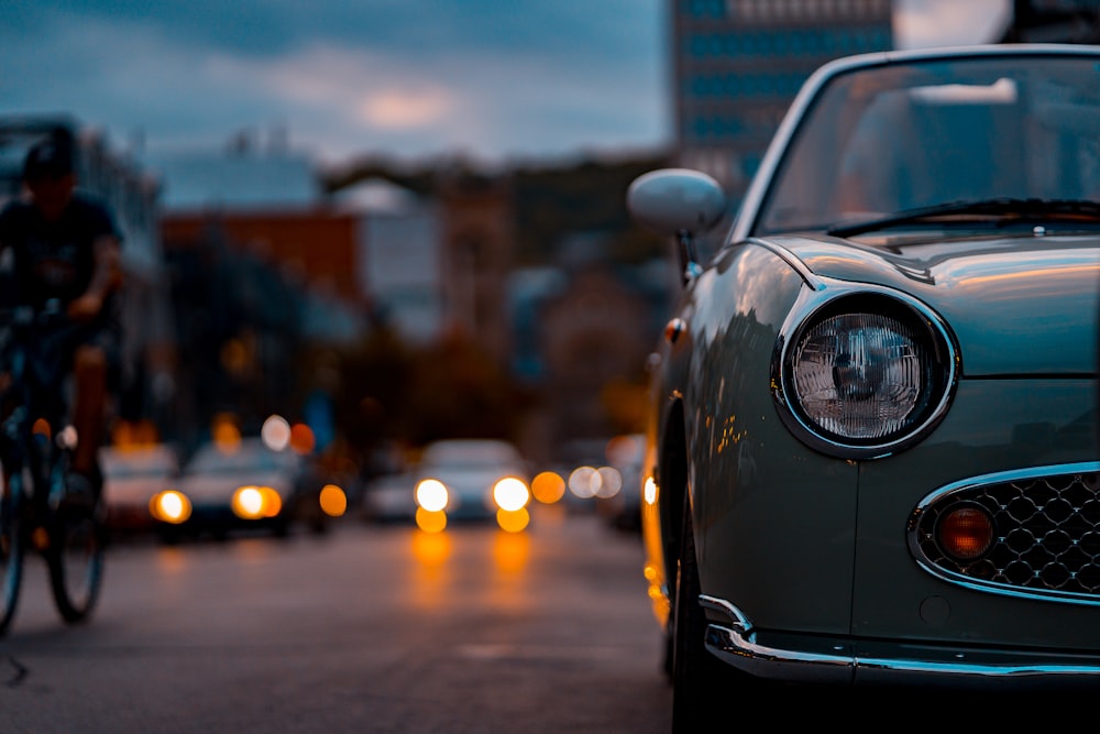 selective focus photography of white car beside road