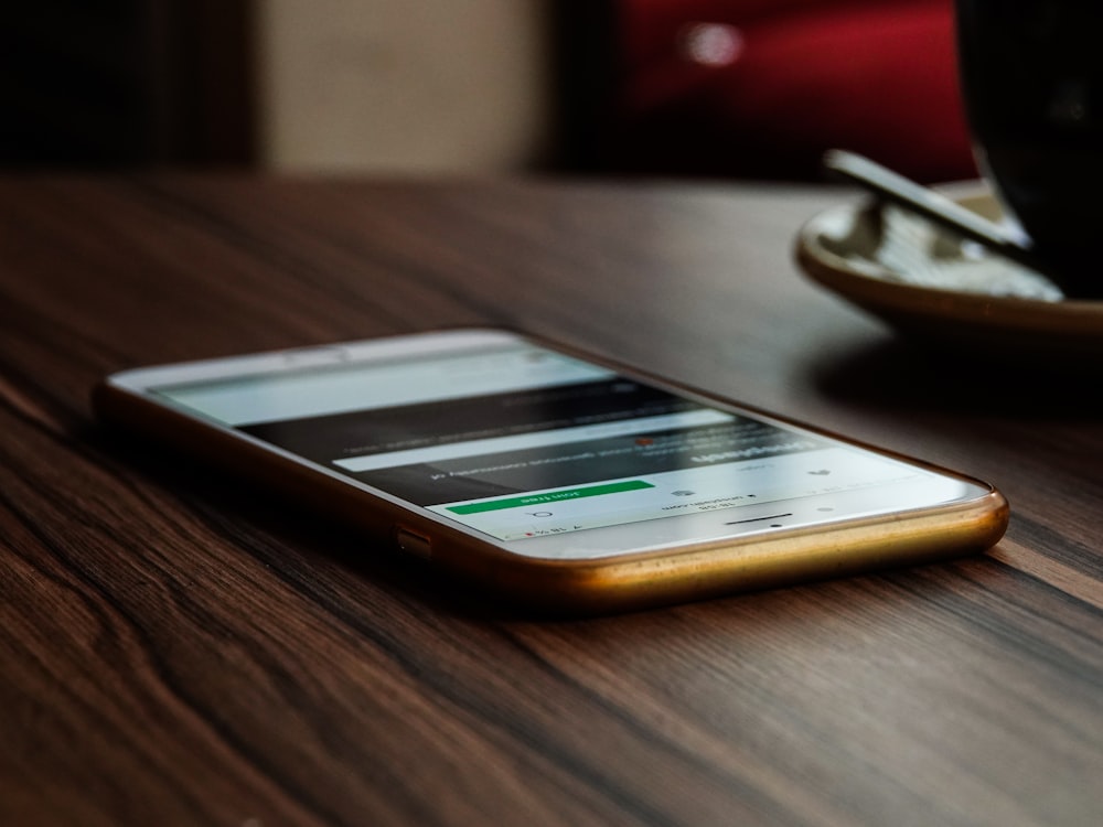 gold iPhone 6 on brown wooden surface