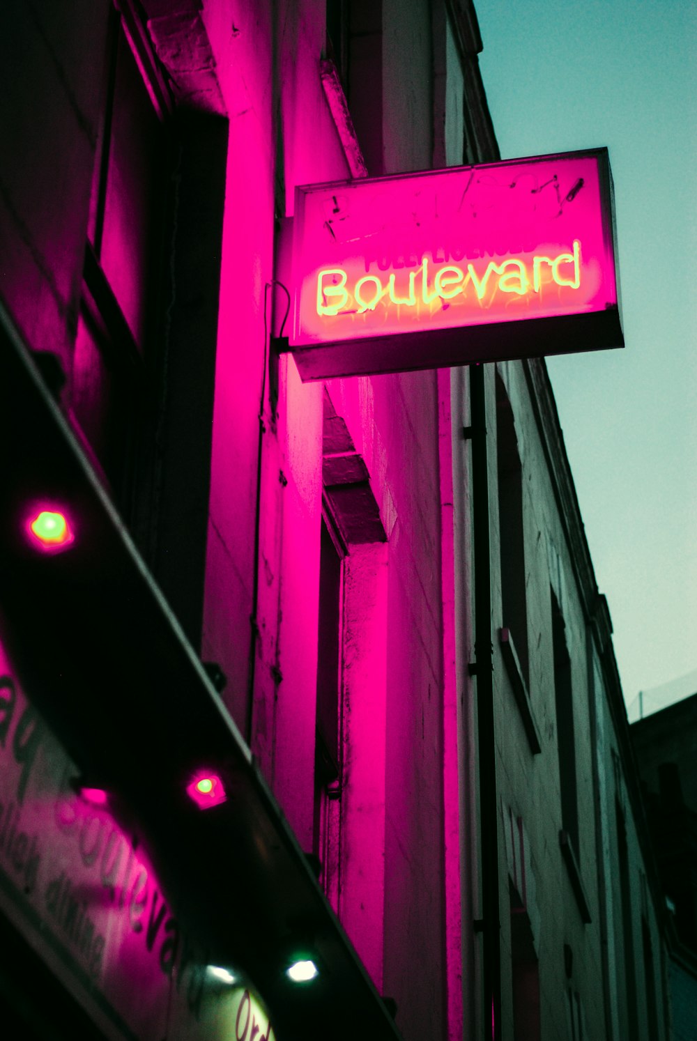 low angle photo of building with boulevard LED signage at night