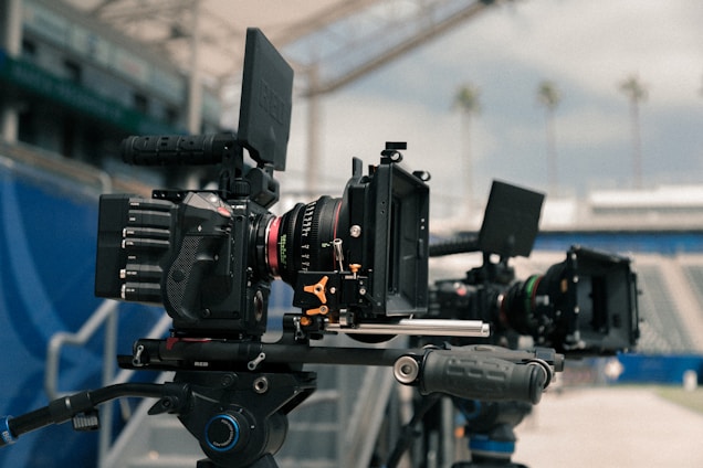 A vibrant team setting up event sales booths with cinematic cameras capturing the atmosphere.