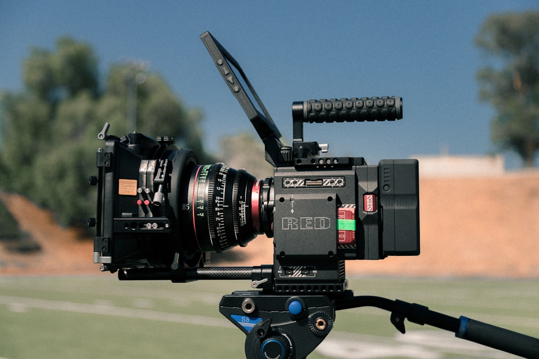 black digital video recorder on black tripod,