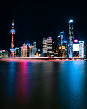 A sleek silhouette of a city skyline at night with soft glowing lights reflecting a futuristic urban vibe.