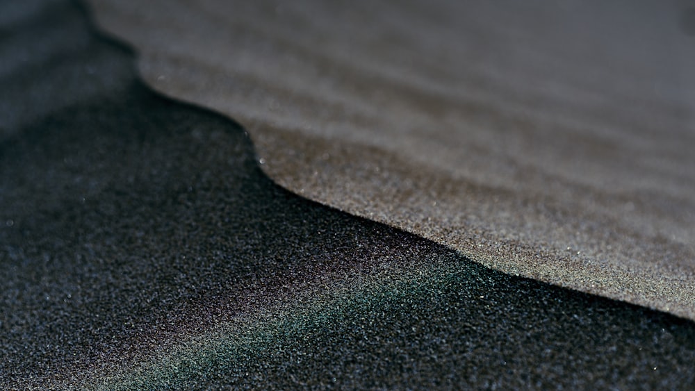 a close up of a sand dune with a blurry background