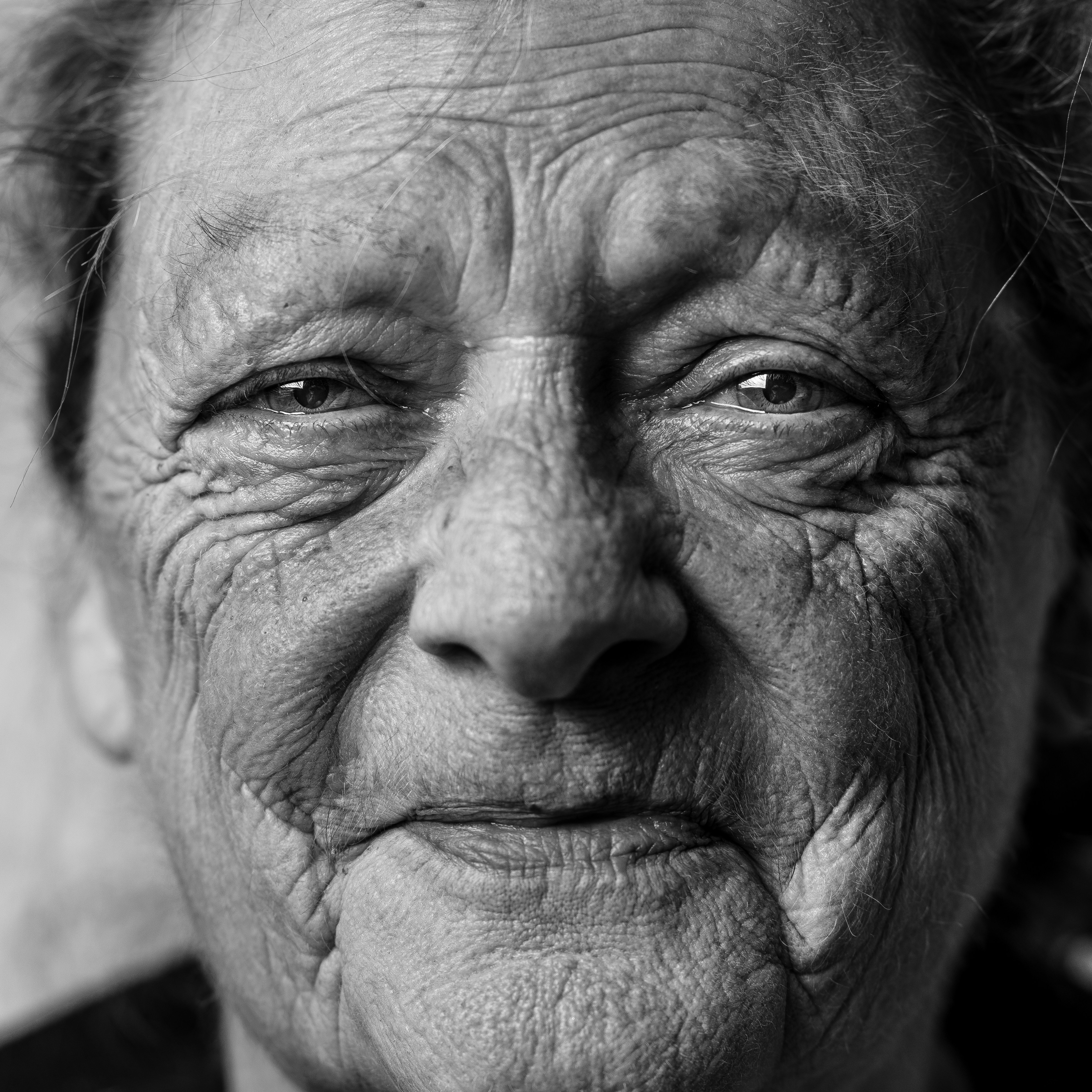 great photo recipe,how to photograph this is a portrait of my mum, trying to show through her facial expression the warmth in her character as well as all the experiences that she has lived in her life. i did the portrait from the living room in the home she has been living for most of her life.; grayscale picture of person's portrait