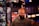 man in gray Thrasher crew-neck shirt standing near commercial refrigerator