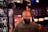 man in gray Thrasher crew-neck shirt standing near commercial refrigerator