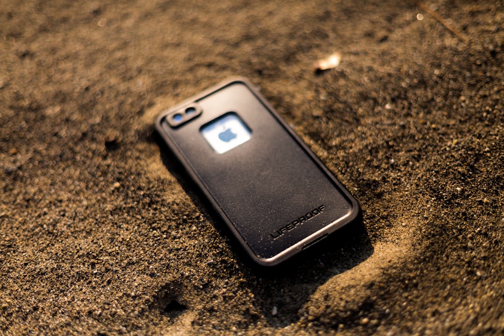 black Lifeproof iPhone case on brown soil