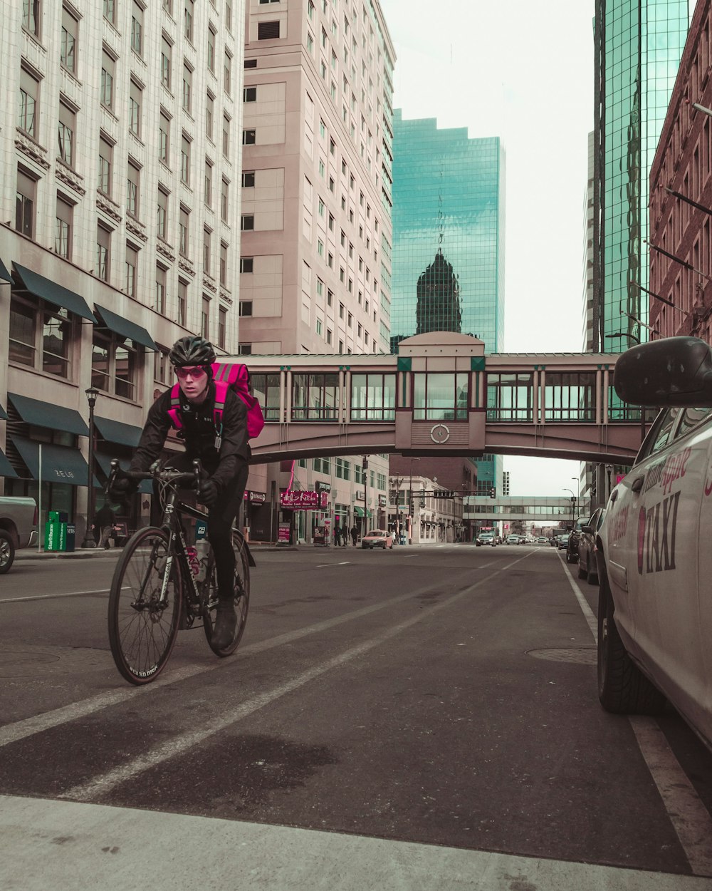 man riding his bicycle on road