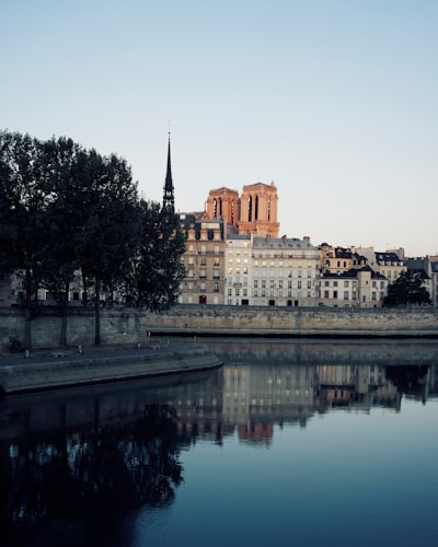 calm body of water near concrete buildings at daytime