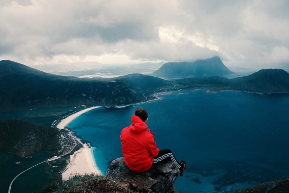 person sitting across body of water