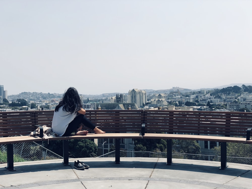 woman sitting on brown bench