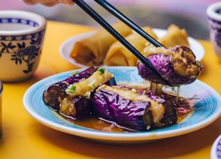 man eating food using chopsticks