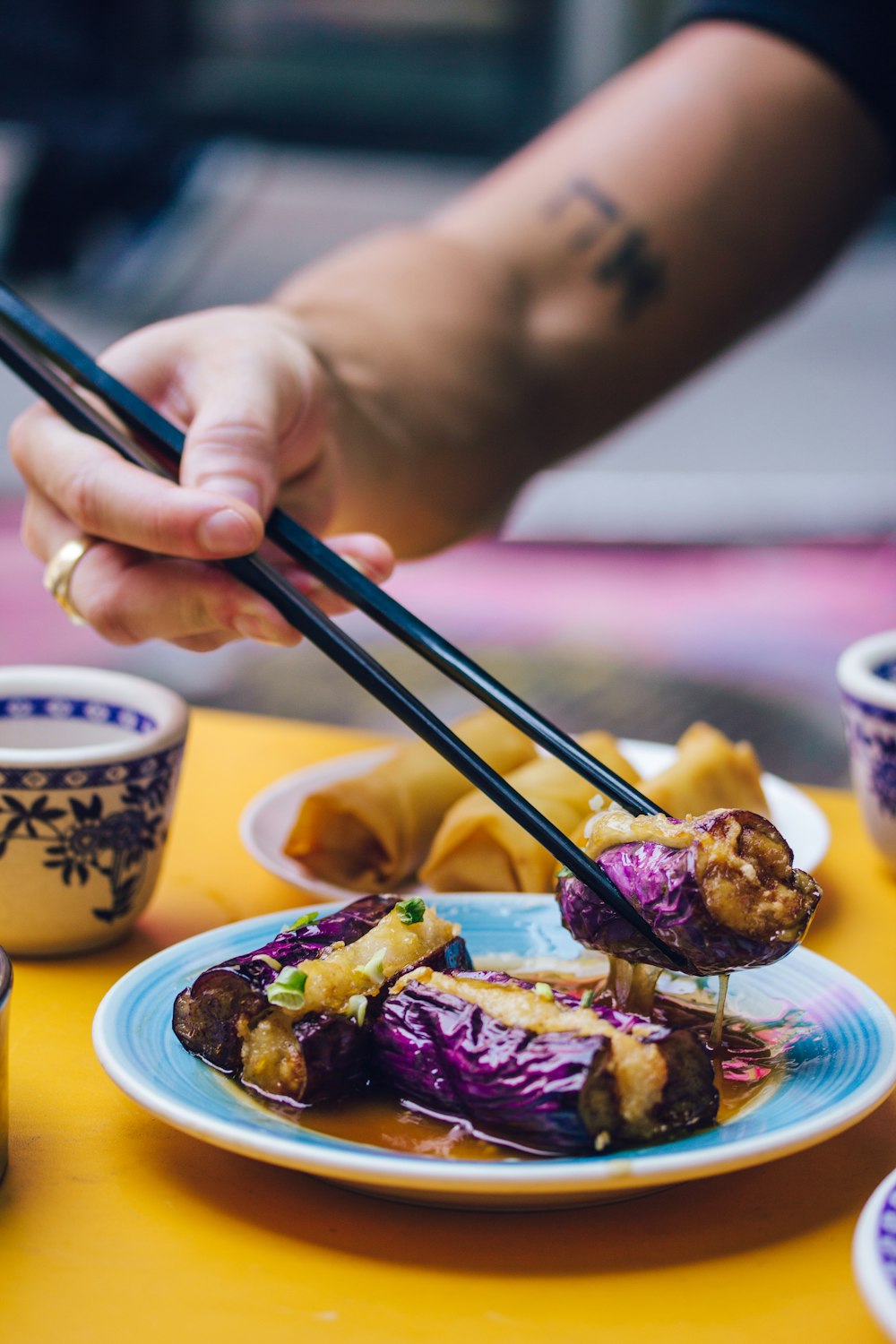 man eating food using chopsticks