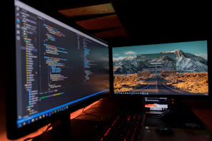 A dual-monitor setup featuring colorful automation scripts and deployment pipelines in action.