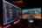 Photo of a focused data scientist reviewing annotated images on a dual-monitor setup.